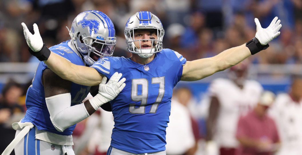 DETROIT, MICHIGAN - SEPTEMBER 18: Aidan Hutchinson #97 of the Detroit Lions is congratulated by Michael Brockers #90 after making his first career sack during the first quarter of the game against the Washington Commanders at Ford Field on September 18, 2022 in Detroit, Michigan.