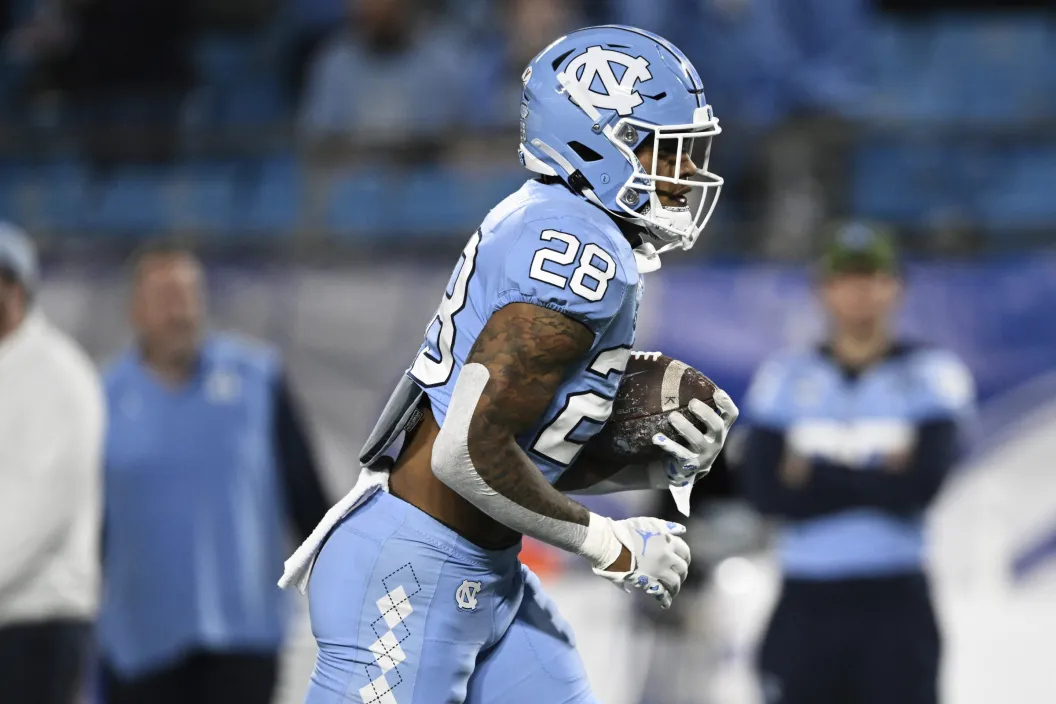 CHARLOTTE, NORTH CAROLINA - DECEMBER 03: Omarion Hampton #28 of the North Carolina Tar Heels warms up before the ACC Championship against the Clemson Tigersat Bank of America Stadium on December 03, 2022 in Charlotte, North Carolina.
