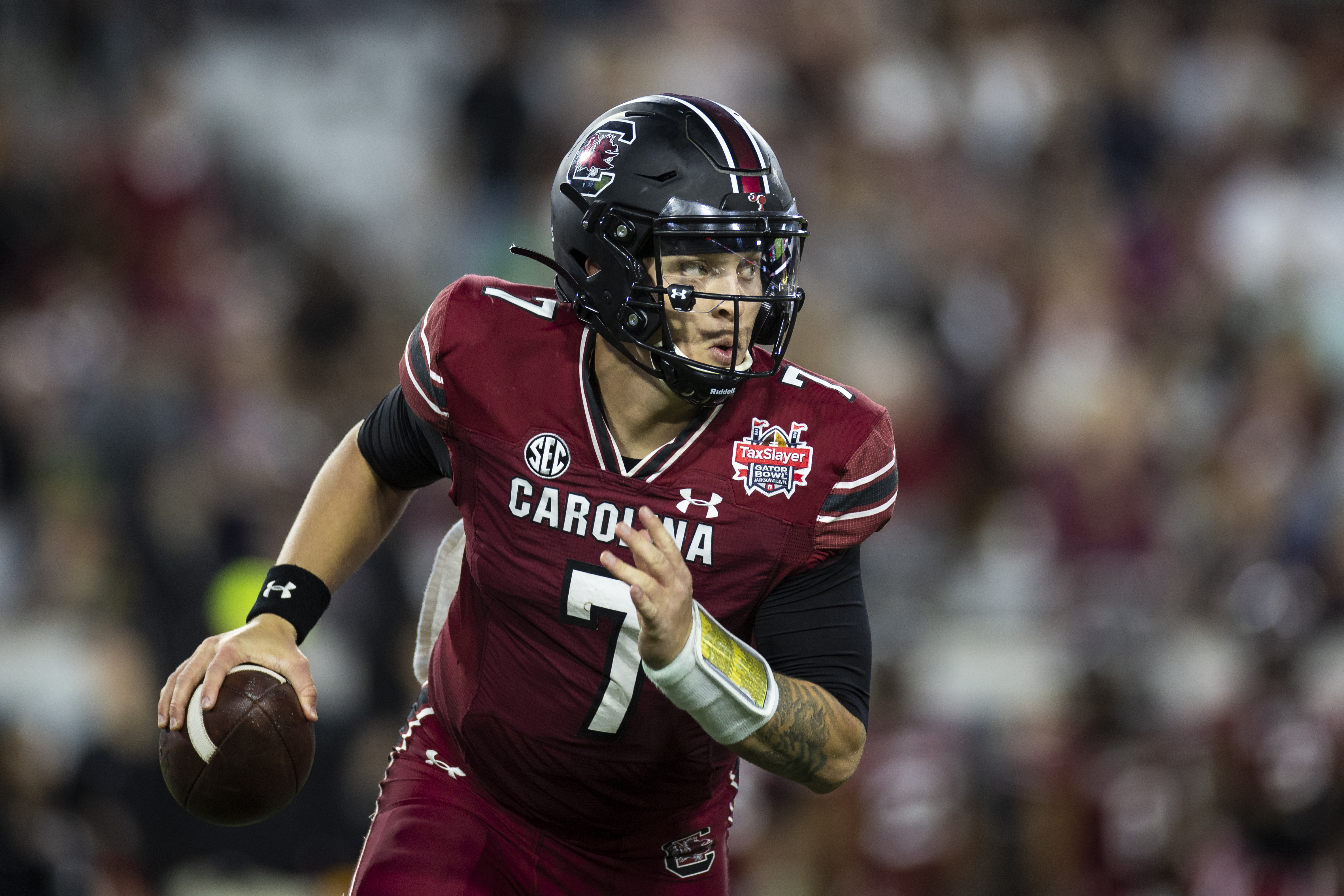 JACKSONVILLE, FLORIDA - DECEMBER 30: Spencer Rattler #7 of the South Carolina Gamecocks looks to pass against the Notre Dame Fighting Irish during the second half of the TaxSlayer Gator Bowl at TIAA Bank Field on December 30, 2022 in Jacksonville, Florida. 
