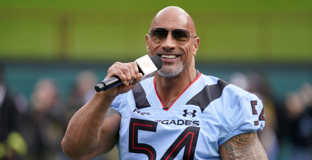 ARLINGTON, TEXAS - FEBRUARY 18: XFL owner Dwayne Johnson talks on the field before the game between the Arlington Renegades and the Vegas Vipers at Choctaw Stadium on February 18, 2023 in Arlington, Texas.