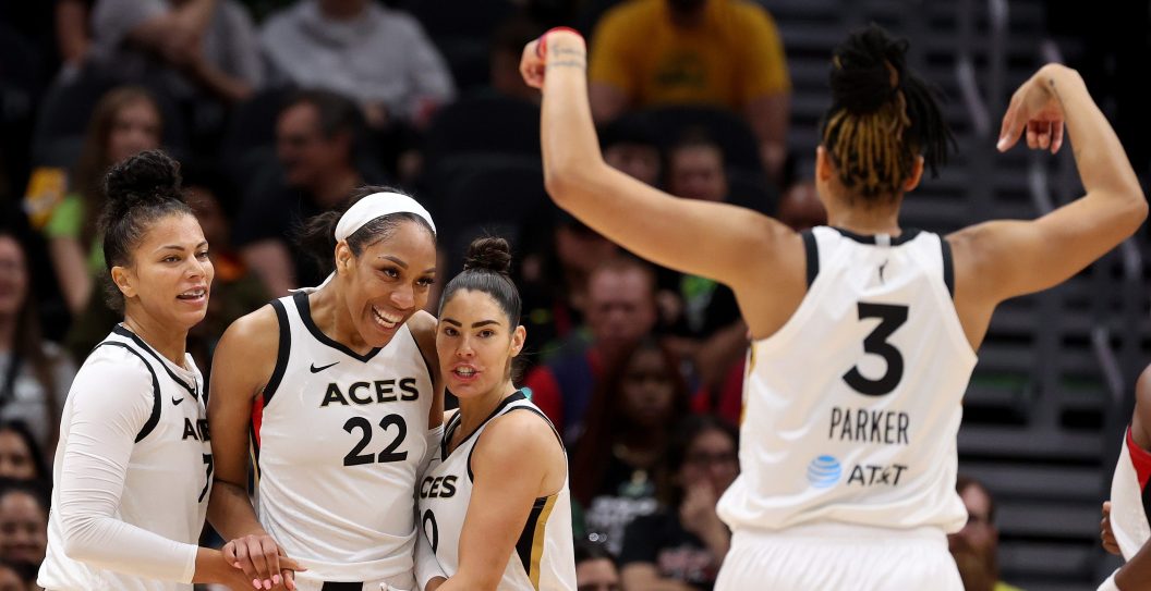 SEATTLE, WASHINGTON - MAY 20: Alysha Clark #7, A'ja Wilson #22, Kelsey Plum #10 and Candace Parker #3 of the Las Vegas Aces react after a basket by Wilson during the second quarter against the Seattle Storm at Climate Pledge Arena on May 20, 2023 in Seattle, Washington.