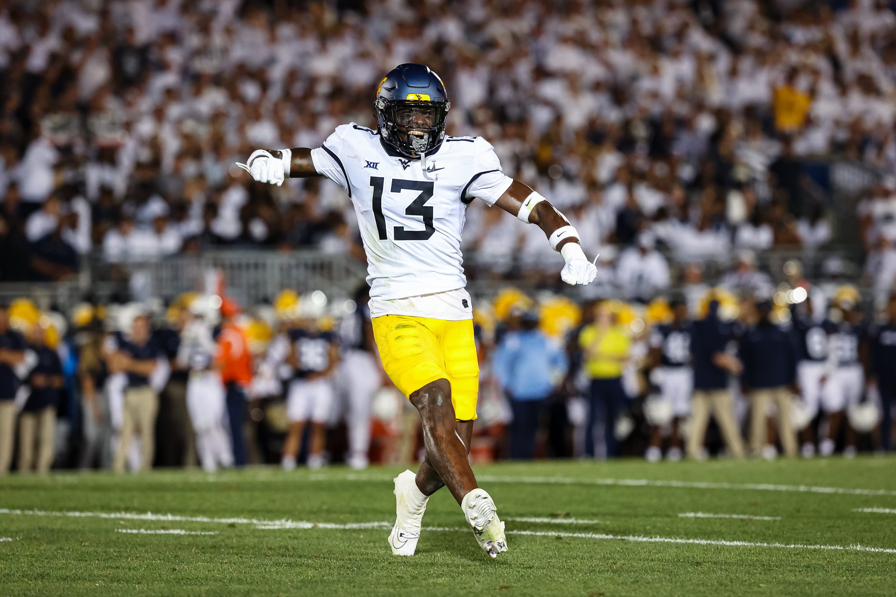STATE COLLEGaE, PA - SEPTEMBER 02: Hershey McLaurin #13 of the West Virginia Mountaineers celebrates after a play against the Penn State Nittany Lions during the first half at Beaver Stadium on September 2, 2023 in State College, Pennsylvania.