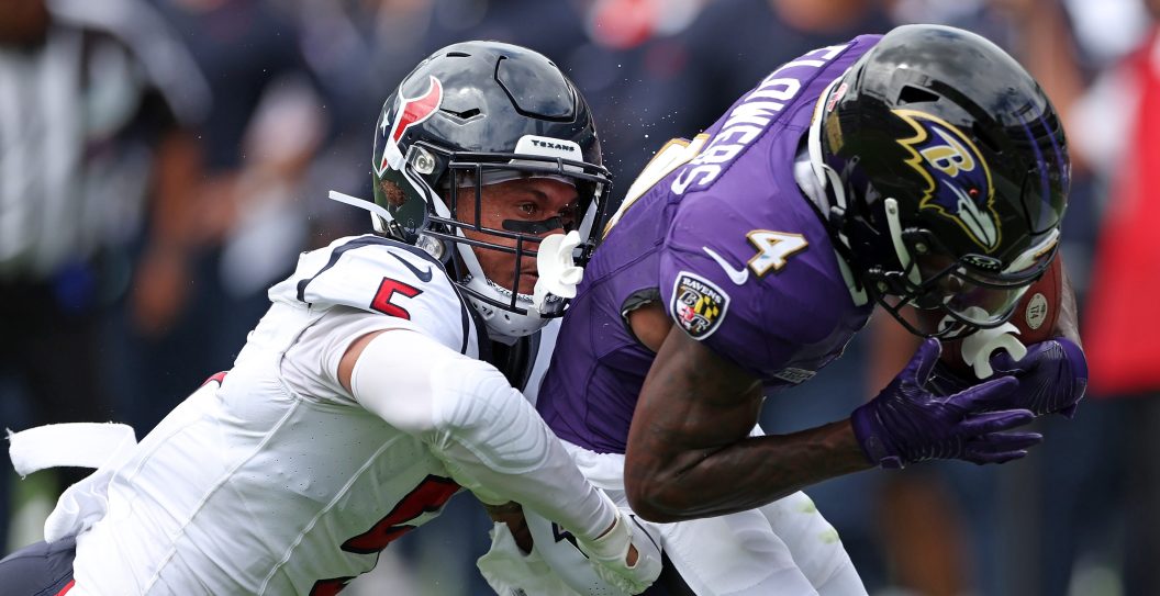 BALTIMORE, MARYLAND - SEPTEMBER 10: Zay Flowers #4 of the Baltimore Ravens catches the pass against Jalen Pitre #5 of the Houston Texans during the first half at M&T Bank Stadium on September 10, 2023 in Baltimore, Maryland.