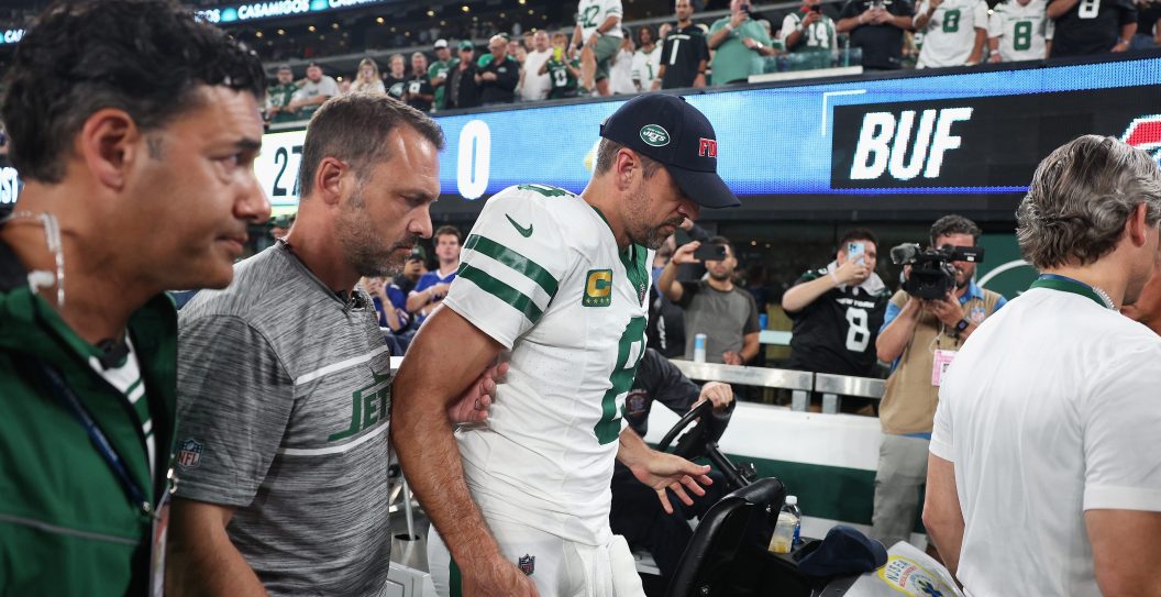 EAST RUTHERFORD, NEW JERSEY - SEPTEMBER 11: Quarterback Aaron Rodgers #8 of the New York Jets is helped off the field after an injury during the first quarter of the NFL game against the Buffalo Bills at MetLife Stadium on September 11, 2023 in East Rutherford, New Jersey.