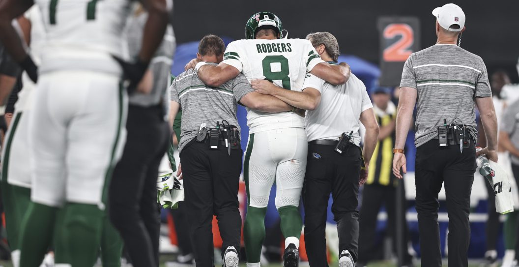 EAST RUTHERFORD, NEW JERSEY - SEPTEMBER 11: Aaron Rodgers #8 of the New York Jets is helped off the field for an apparent injury during a game against the Buffalo Bills at MetLife Stadium on September 11, 2023 in East Rutherford, New Jersey. (