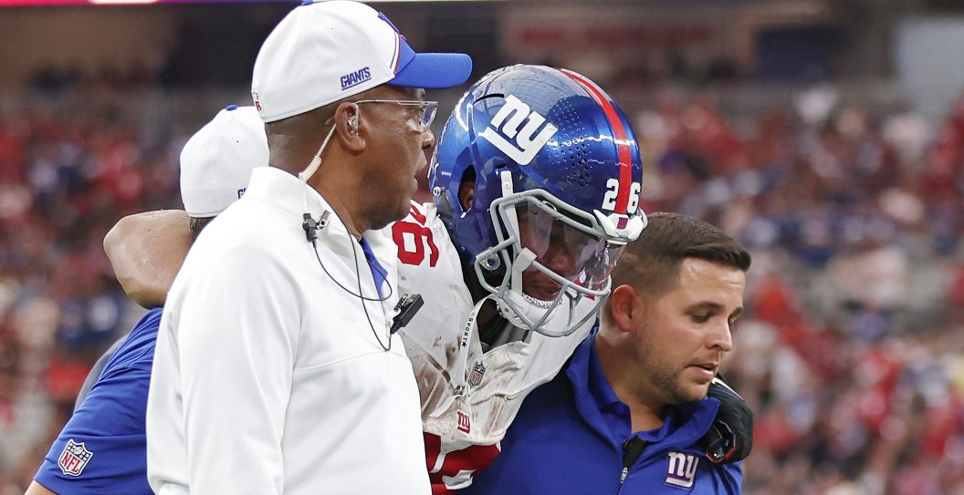 Saquon Barkley #26 of the New York Giants is helped off the field during the fourth quarter in the game against the Arizona Cardinals at State Farm Stadium on September 17, 2023 in Glendale, Arizona.