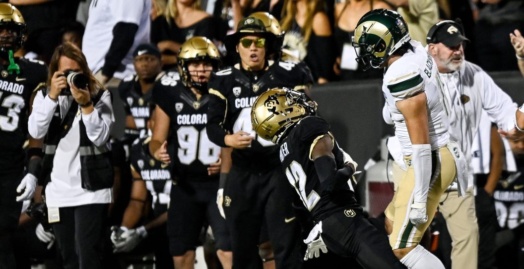 BOULDER, CO - SEPTEMBER 16: Wide receiver Travis Hunter #12 of the Colorado Buffaloes is hit near the sideline on a pass attempt by defensive back Henry Blackburn #11 of the Colorado State Rams at Folsom Field on September 16, 2023 in Boulder, Colorado.