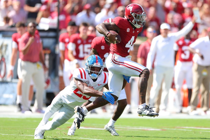 Jalen Milroe runs with the ball for Alabama.