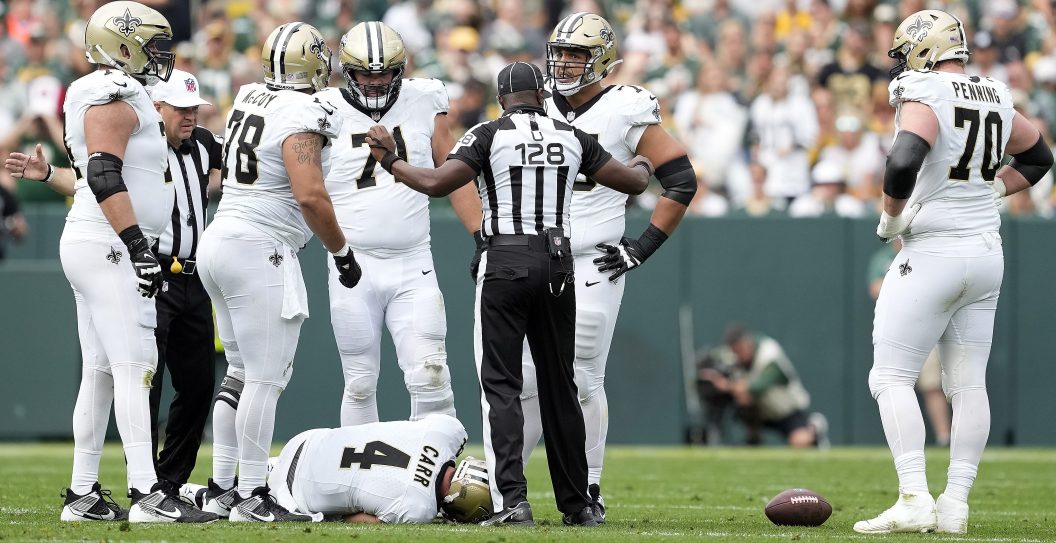 Derek Carr #4 of the New Orleans Saints lays on the ground after a play .