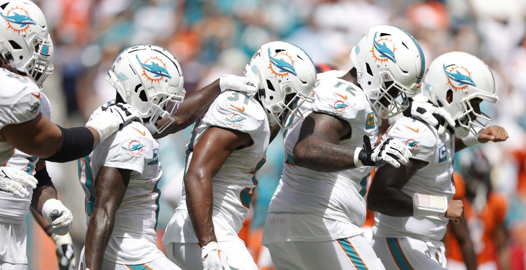 Tyreek Hill #10 of the Miami Dolphins and Raheem Mostert #31 of the Miami Dolphins, Terron Armstead #72 of the Miami Dolphins, and Tua Tagovailoa #1 of the Miami Dolphins celebrate after Mostert's rushing touchdown during the second quarter against the Denver Broncos at Hard Rock Stadium
