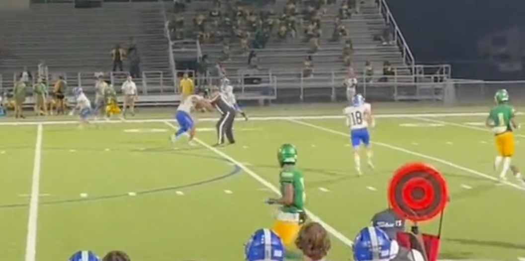 High school referee rips a player's helmet off during a play.