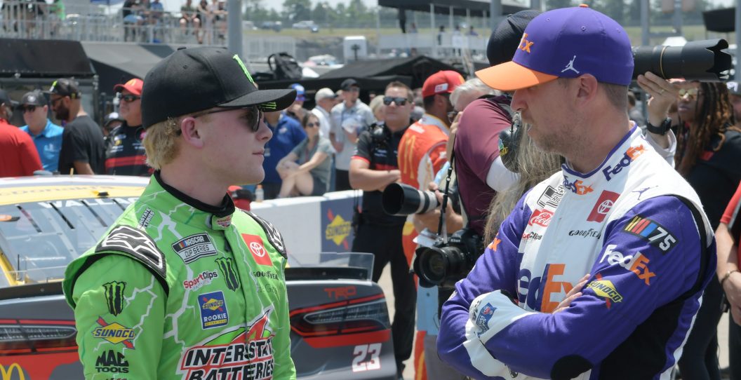NASHVILLE, TN - JUNE 24: Teammates Ty Gibbs (#54 Joe Gibbs Racing Interstate Batteries Toyota) and Denny Hamlin (#11 Joe Gibbs Racing FedEx Ground Toyota) talk during qualifying for the NASCAR Cup Series Ally 400 on June 24, 2023, at Nashville Superspeedway in Lebanon, TN.