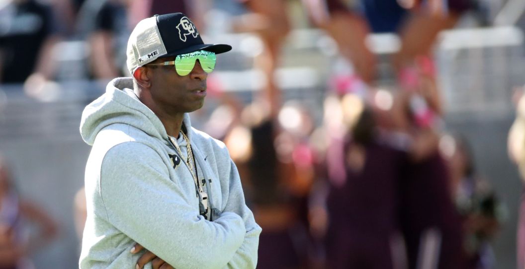 Deion Sanders with his arms crossed at Colorado.
