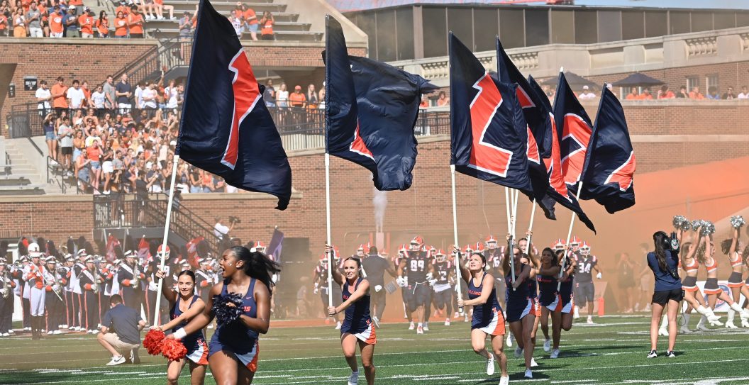 CHAMPAIGN, IL - SEPTEMBER 23: The Illinois cheer squad leads the team onto the field before a college football game between the Florida Atlantic Owls and the Illinois Fighting Illini on September 23, 2023, at Memorial Stadium in Champaign, Ill.