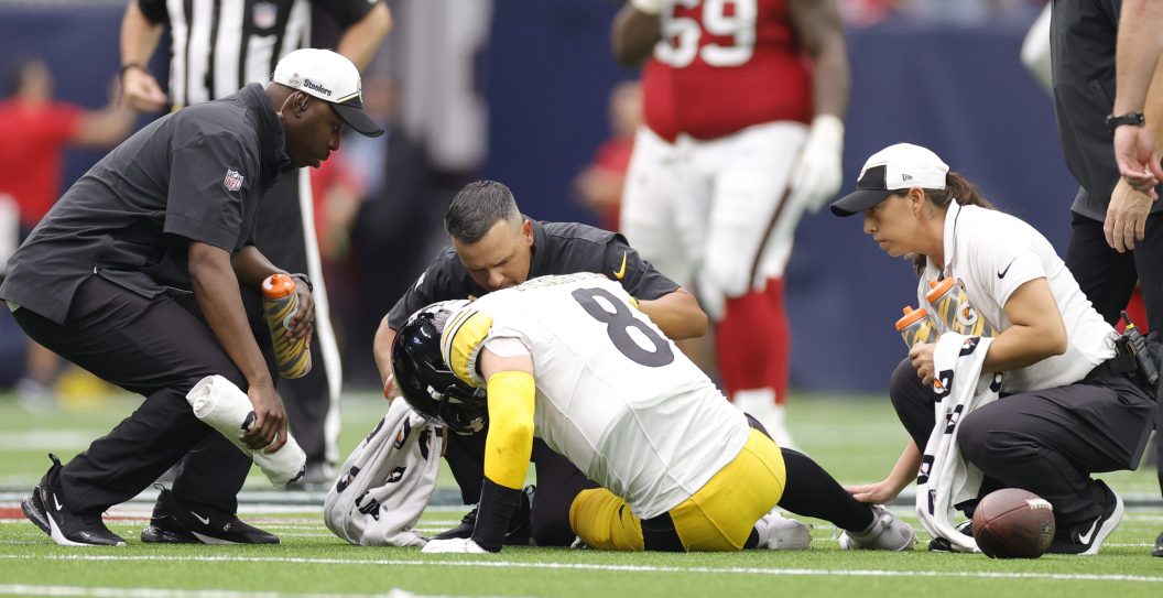 HOUSTON, TEXAS - OCTOBER 01: Pittsburgh Steelers medical staff looks at Kenny Pickett #8 of the Pittsburgh Steelers during the third quarter against the Houston Texans at NRG Stadium on October 01, 2023 in Houston, Texas.