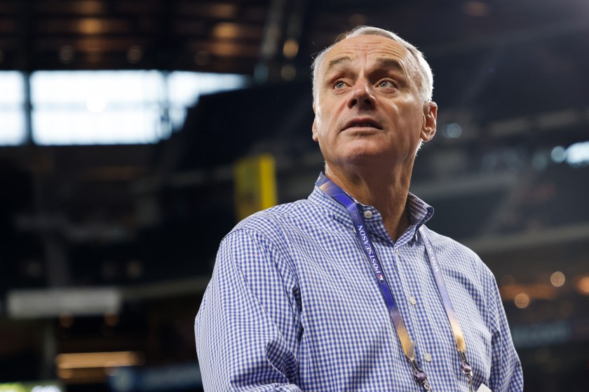 Rob Manfred looks on before a playoff game in Arlington.