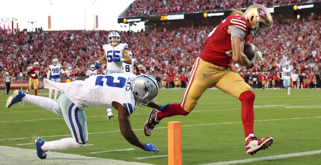 George Kittle #85 of the San Francisco 49ers runs for a touchdown after a catch during the second quarter against the Dallas Cowboys