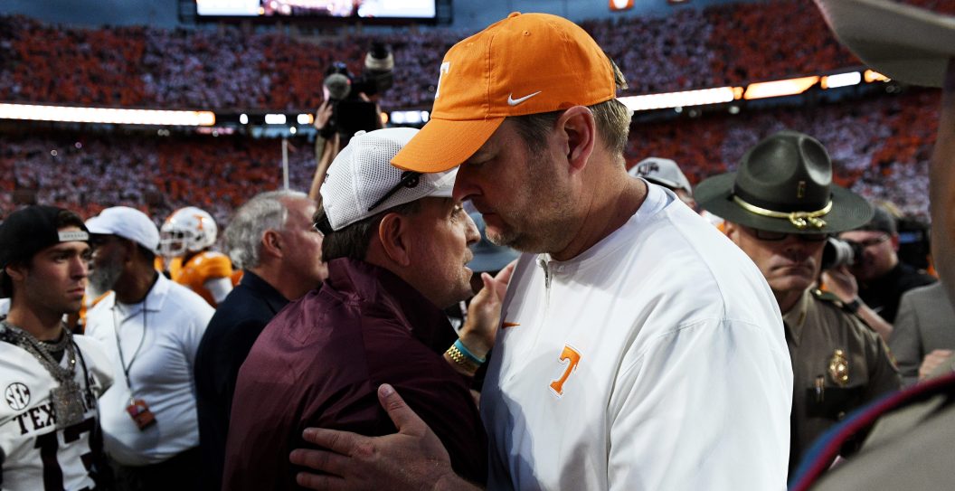 KNOXVILLE, TENNESSEE - OCTOBER 14: Head coach Josh Heupel of the Tennessee Volunteers and head coach Jimbo Fisher of the Texas A&M Aggies shake hands following their game at Neyland Stadium on October 14, 2023 in Knoxville, Tennessee.