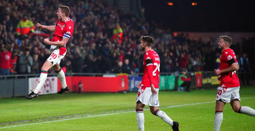 Wrexham's Paul Mullin (left) celebrates scoring their side's first goal of the game during the Sky Bet League Two match at The Racecourse Ground, Wrexham. Picture date: Tuesday October 24, 2023.