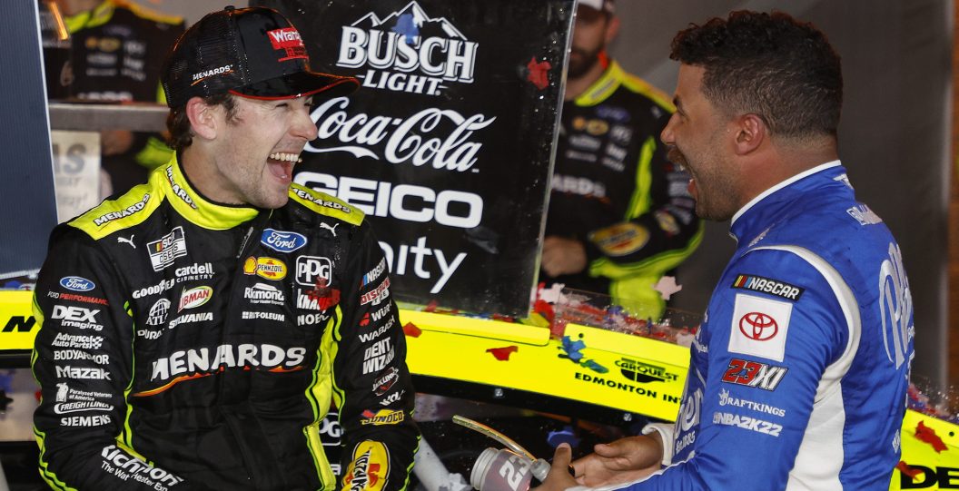 FORT WORTH, TEXAS - MAY 22: Ryan Blaney, driver of the #12 Menards/Wrangler Ford, is congratulated by Bubba Wallace, driver of the #23 Dr. Pepper Dark Berry Toyota, in victory lane after winning the NASCAR Cup Series All-Star Race at Texas Motor Speedway on May 22, 2022 in Fort Worth, Texas.