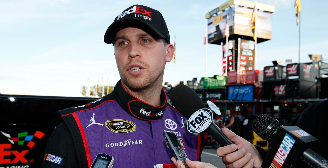 LOUDON, NH - SEPTEMBER 25: Denny Hamlin, driver of the #11 FedEx Freight Toyota, is interviewed after qualifying for the NASCAR Sprint Cup Series Sylvania 300 at New Hampshire Motor Speedway on September 25, 2015 in Loudon, New Hampshire.