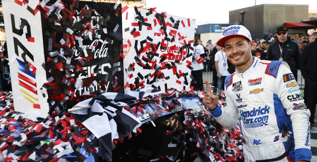 RICHMOND, VIRGINIA - APRIL 02: Kyle Larson, driver of the #5 HendrickCars.com Chevrolet, poses next to his winner sticker in victory lane after winning the NASCAR Cup Series Toyota Owners 400 at Richmond Raceway on April 02, 2023 in Richmond, Virginia.