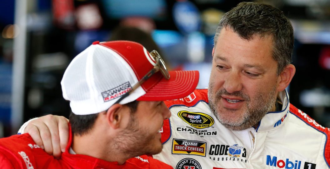 LOUDON, NH - JULY 15: Tony Stewart, driver of the #14 Haas Automation Chevrolet, speaks with Kyle Larson, driver of the #42 Target Chevrolet, in the garage area during practice for the NASCAR Sprint Cup Series New Hampshire 301 at New Hampshire Motor Speedway on July 16, 2016 in Loudon, New Hampshire.