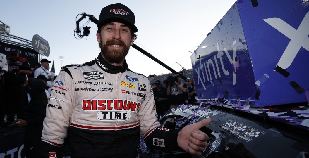 MARTINSVILLE, VIRGINIA - OCTOBER 29: Ryan Blaney, driver of the #12 Discount Tire Ford, poses next to his winner sticker in victory lane after winning the NASCAR Cup Series Xfinity 500 at Martinsville Speedway on October 29, 2023 in Martinsville, Virginia.