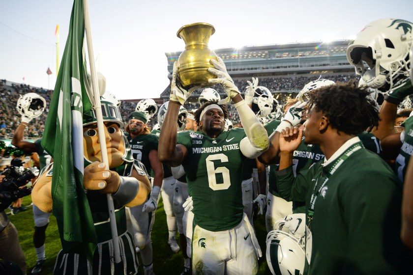 EAST LANSING, MI - SEPTEMBER 28: Michigan State safety David Dowell (6) raises the Old Brass Spittoon after a college football game between the Michigan State Spartans and Indiana Hoosiers on September 28, 2019 at Spartan Stadium in East Lansing, MI. 