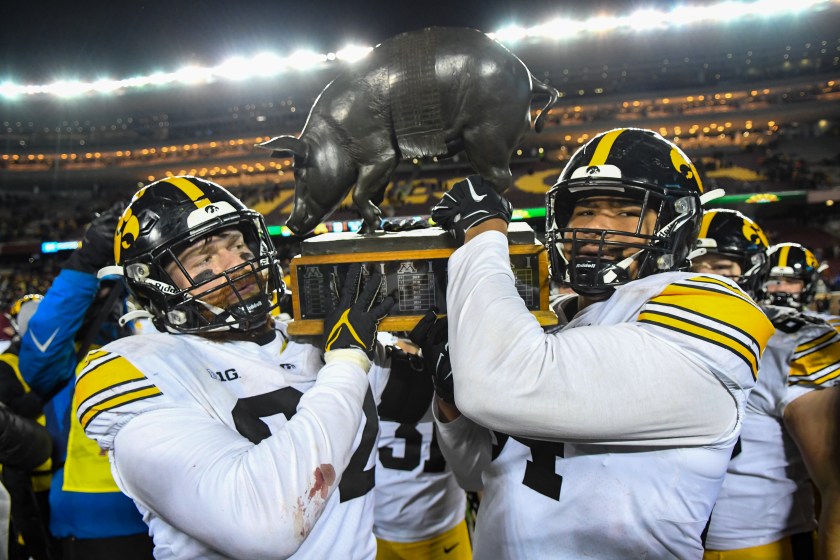 MINNEAPOLIS, MN - NOVEMBER 19: Iowa Hawkeyes defensive linemen Jason Waggoner (92) and Iowa Hawkeyes defensive end Dominic Wiseman (54) hold the Floyd of Rosedale trophy after a college football game between the Minnesota Golden Gophers and Iowa Hawkeyes on November 19, 2022 at Huntington Bank Stadium in Minneapolis, MN.