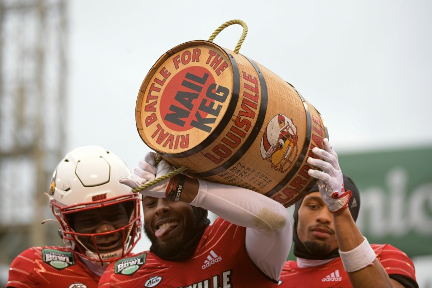 Louisville players hold up the Keg of Nails.