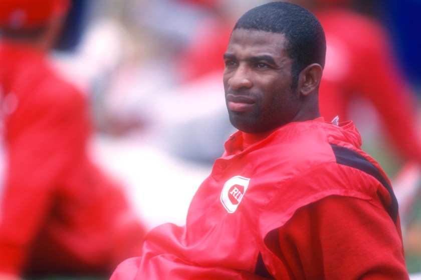 Deion Sanders sits down while playing for the Reds in 1997.