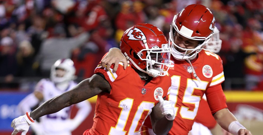 KANSAS CITY, MISSOURI - JANUARY 23: Tyreek Hill #10 of the Kansas City Chiefs celebrates with teammate Patrick Mahomes #15 after scoring a 64 yard touchdown against the Buffalo Bills during the fourth quarter in the AFC Divisional Playoff game at Arrowhead Stadium on January 23, 2022 in Kansas City, Missouri.