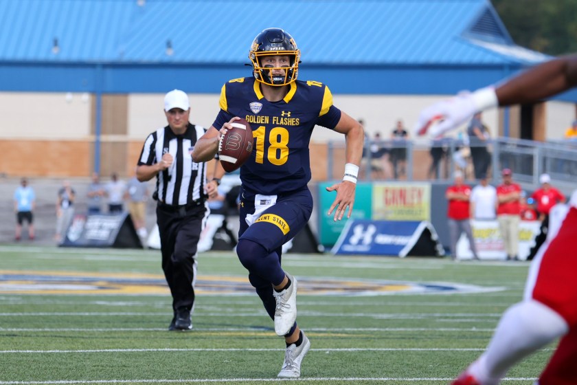 Kent State's quarterback runs with the ball.