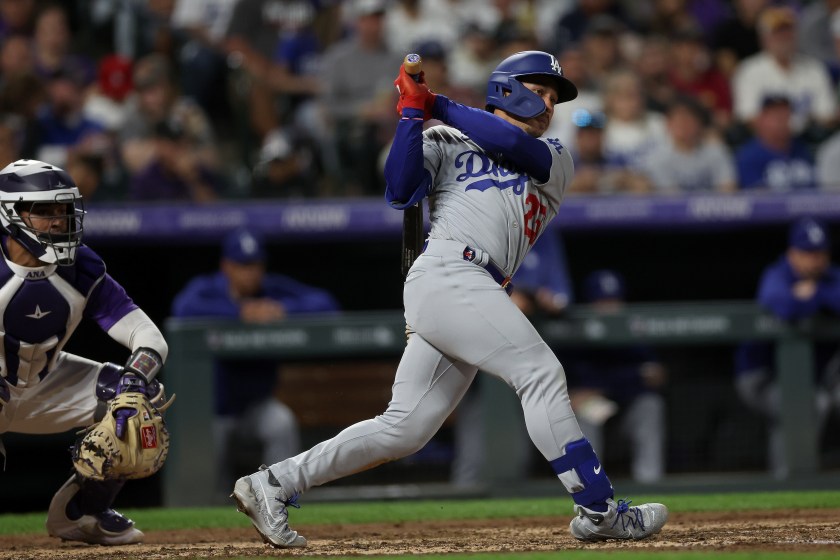 DENVER, COLORADO - SEPTEMBER 26: Kolten Wong #25 of the Los Angeles Dodgers hits a RBI single against the Colorado Rockies in the fifth inning during Game Two of a Doubleheader at Coors Field on September 26, 2023 in Denver, Colorado. 