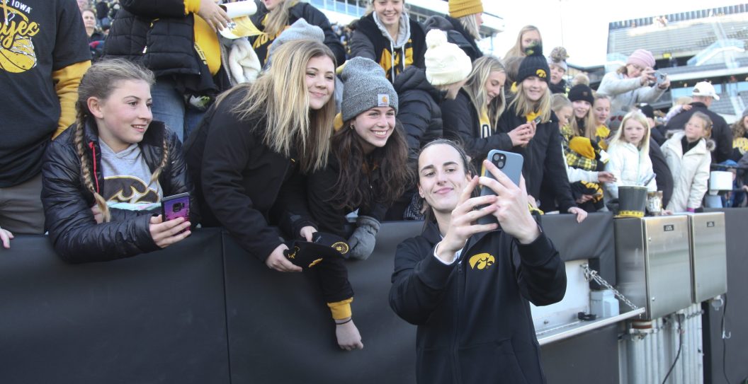 IOWA CITY, IOWA- OCTOBER 15: Guard Caitlin Clark #22 of the Iowa Hawkeyes interacts with fans after the match-up against the DePaul Blue Demons at Kinnick Stadium during the Crossover at Kinnick event on October 15, 2023 in Iowa City, Iowa.