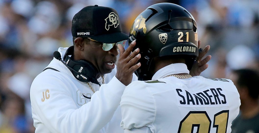 Pasadena, CA - Colorado coach Deon Sanders talks with his son, Colorado defensive back Shilo Sanders, before the game against UCLA at the Rose Bowl on Saturday, Oct. 28, 2023.