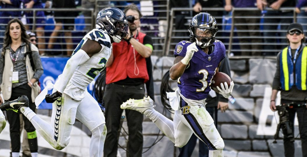 BALTIMORE, MD - NOVEMBER 05: Baltimore Ravens running back Keaton Mitchell (34) runs for a touchdown against Seattle Seahawks cornerback Riq Woolen (27) during the Seattle Seahawks game versus the Baltimore Ravens on November 5, 2023 at M&T Bank Stadium in Baltimore, MD.