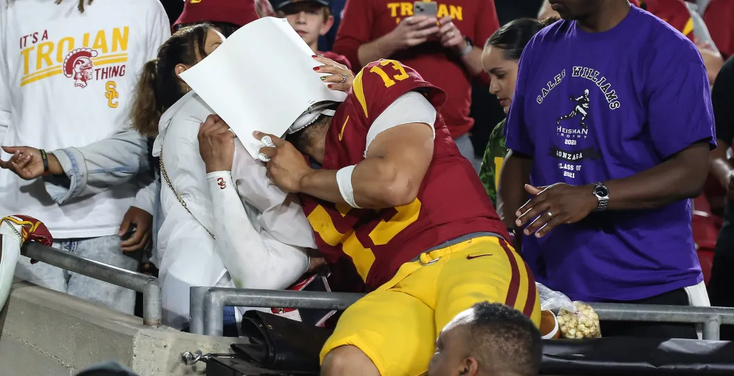 LOS ANGELES, CA - NOVEMBER 04: USC Trojans quarterback Caleb Williams (13) shares a moment with his family after being defeated by the Washington Huskies on November 04, 2023, at the Los Angeles Memorial Coliseum in Los Angeles, CA.