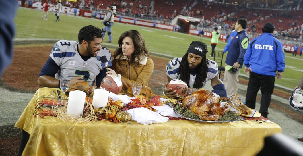 SANTA CLARA, CA - NOVEMBER 27: Richard Sherman #25 and Russell Wilson #3 of the Seattle Seahawks eat post game turkey, provided by NBC, on the field following the game against the San Francisco 49ers at Levi Stadium on November 27, 2014 in Santa Clara, California. The Seahawks defeated the 49ers 19-3.