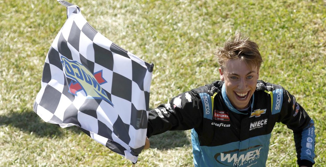 HOMESTEAD, FLORIDA - OCTOBER 21: Carson Hocevar, driver of the #42 Worldwide Express Chevrolet, celebrates with the checkered flag after winning the NASCAR Craftsman Truck Series Baptist Health Cancer Care 200 at Homestead-Miami Speedway on October 21, 2023 in Homestead, Florida.