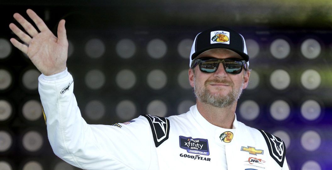 HOMESTEAD, FLORIDA - OCTOBER 21: Dale Earnhardt Jr., driver of the #88 Bass Pro Shops/Tracker Boats Chevrolet, waves to fans as he walks onstage during driver intros prior to the NASCAR Xfinity Series Contender Boats 300 at Homestead-Miami Speedway on October 21, 2023 in Homestead, Florida.