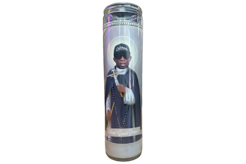 A candle with Deion Sanders on it.