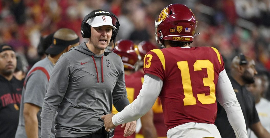 LAS VEGAS, NEVADA - DECEMBER 02: Head coach Lincoln Riley of the USC Trojans talks with Caleb Williams #13 against the Utah Utes during the third quarter in the Pac-12 Championship at Allegiant Stadium on December 02, 2022 in Las Vegas, Nevada.