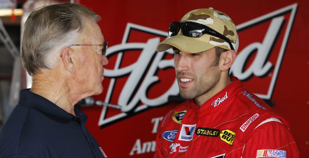 HOMESTEAD, FL - NOVEMBER 20: Team owner Joe Gibbs (L) talks with Aric Almirola, driver of the #9 Budweiser Ford, in the garage during practice for the NASCAR Sprint Cup Series Ford 400 at Homestead-Miami Speedway on November 20, 2010 in Homestead, Florida.
