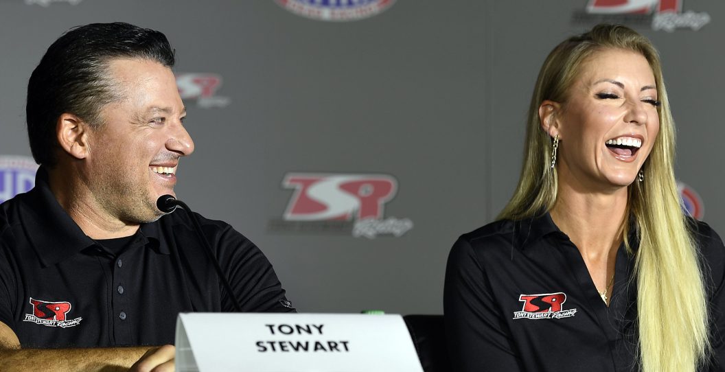CONCORD, NORTH CAROLINA - OCTOBER 14: Tony Stewart and Leah Pruett laugh during the press conference held at the zMAX Dragway on October 14, 2021 in Concord, North Carolina.
