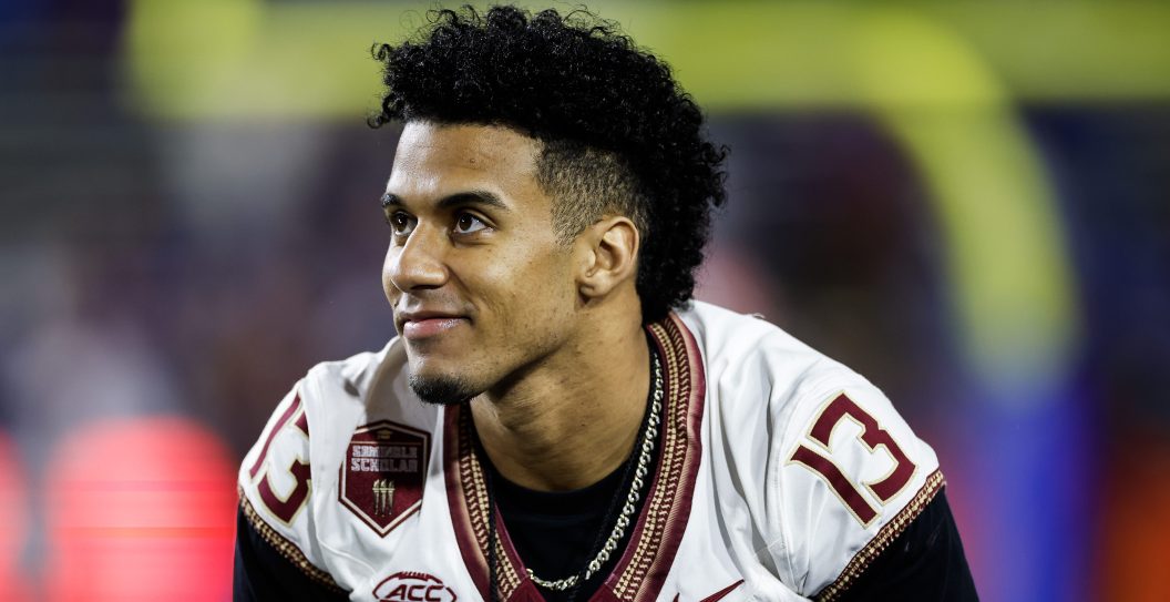 GAINESVILLE, FLORIDA - NOVEMBER 25: Jordan Travis #13 of the Florida State Seminoles looks on from the Seminoles bench before the start of a game against the Florida Gators at Ben Hill Griffin Stadium on November 25, 2023 in Gainesville, Florida.