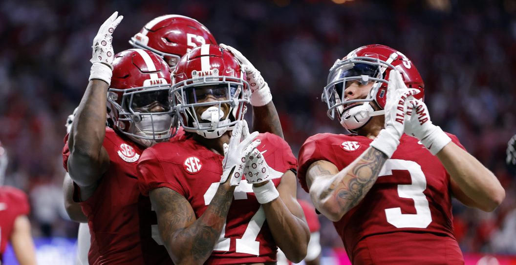 ATLANTA, GEORGIA - DECEMBER 02: Isaiah Bond #17, Jermaine Burton #3 and Roydell Williams #5 of the Alabama Crimson Tide react after a catch during the fourth quarter against the Georgia Bulldogs in the SEC Championship at Mercedes-Benz Stadium on December 02, 2023 in Atlanta, Georgia.