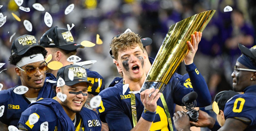HOUSTON, TX - JANUARY 08: Michigan Wolverines quarterback J.J. McCarthy (9) celebrates with the trophy for winning the CFP National Championship football game between the Washington Huskies and Michigan Wolverines at NRG Stadium on January 8, 2024 in Houston, Texas.