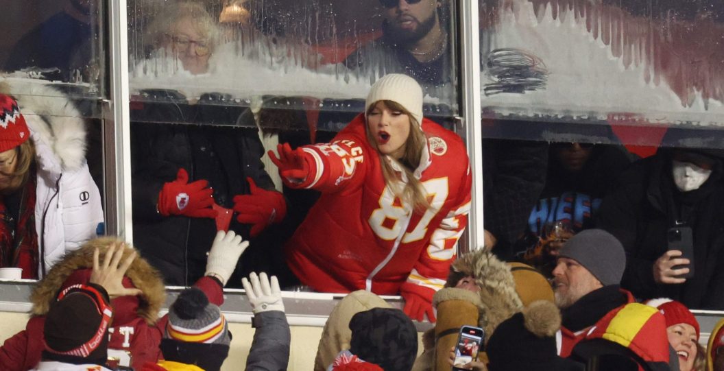 KANSAS CITY, MISSOURI - JANUARY 13: Taylor Swift celebrates with fans during the AFC Wild Card Playoffs between the Miami Dolphins and the Kansas City Chiefs at GEHA Field at Arrowhead Stadium on January 13, 2024 in Kansas City, Missouri.